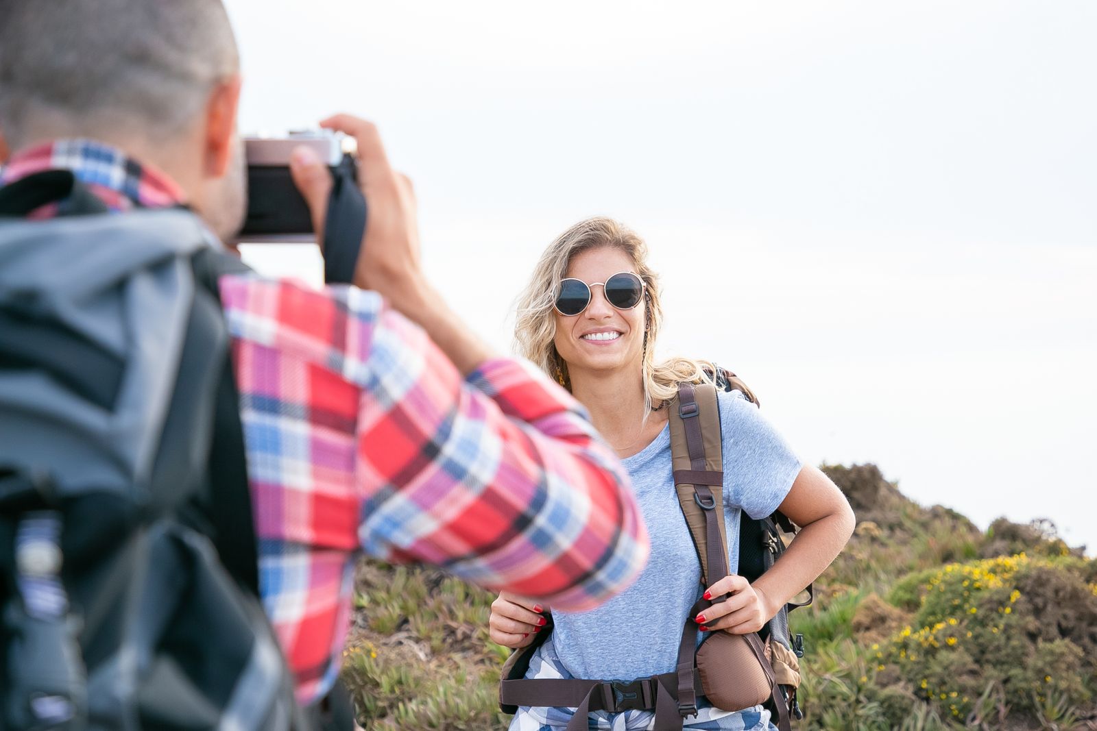 A traveller laughing on the trail, wind in her hair